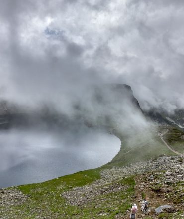 Scenic view of foggy lakes surrounded by mountain terrain, perfect for adventurous hikes.