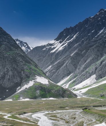 Breathtaking view of snow-capped mountains and winding rivers in Forest Block, showcasing the beauty of winter.